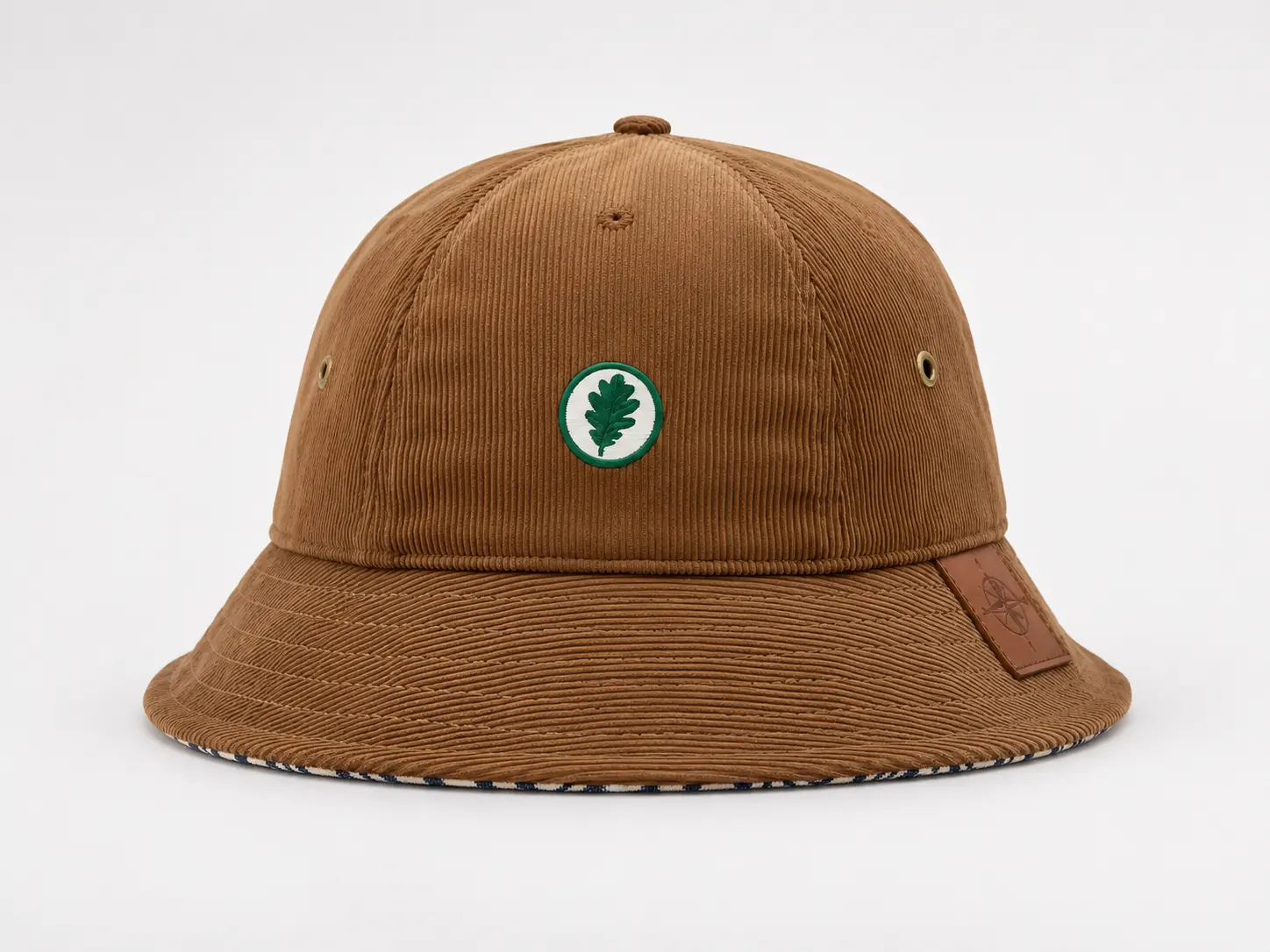 Custom corduroy bucket hat with small embroidered logo and premium fabric texture